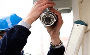 man installing Security Camera